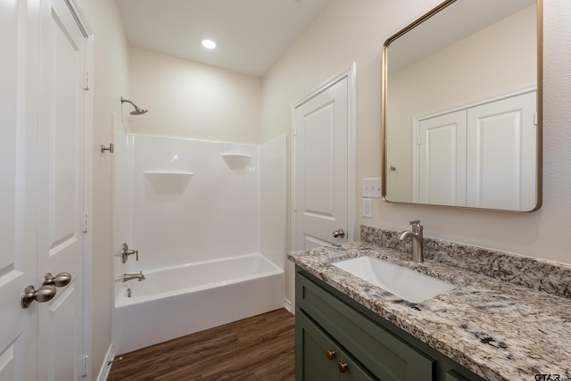 bathroom with wood-type flooring, vanity, and bathing tub / shower combination