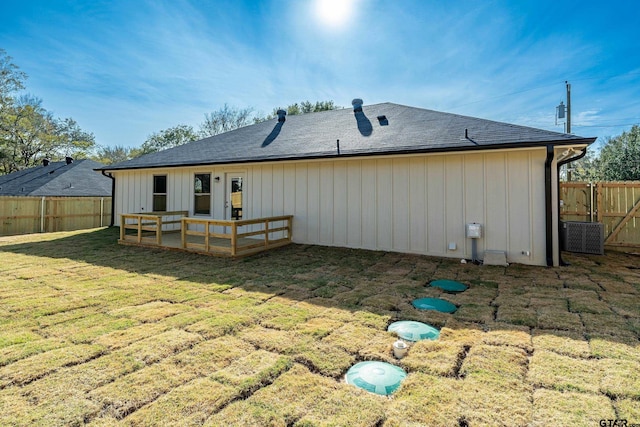 back of house with a lawn and a wooden deck