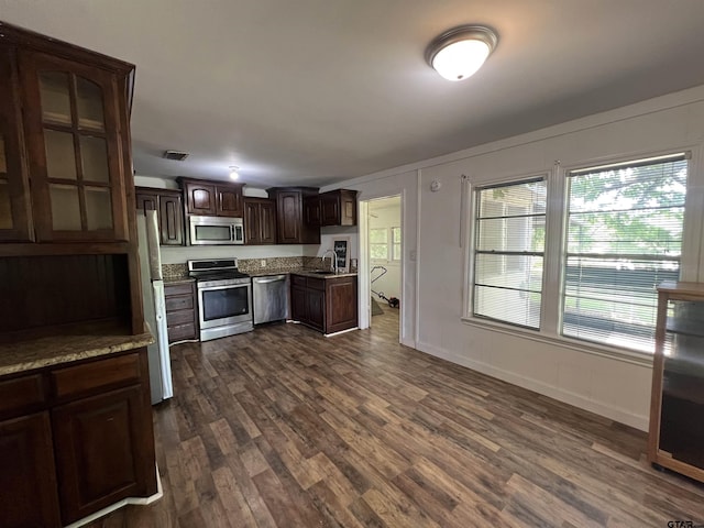 201 First St, Naples, TX 75568 - kitchen with appliances with stainless steel finishes, a sink, dark brown cabinetry, and dark wood finished floors