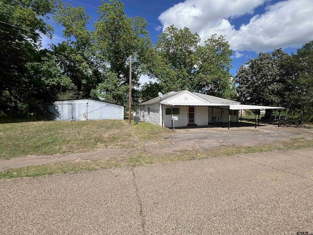 201 First St, Naples, TX 75568 - view of side of home featuring a carport