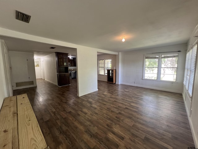 201 First St, Naples, TX 75568 - unfurnished living room featuring dark wood finished floors and baseboards