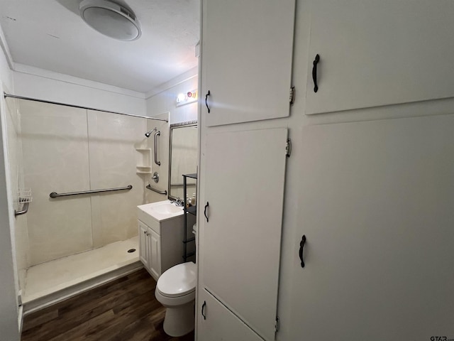 201 First St, Naples, TX 75568 - full bath featuring a shower, wood finished floors, toilet, and vanity