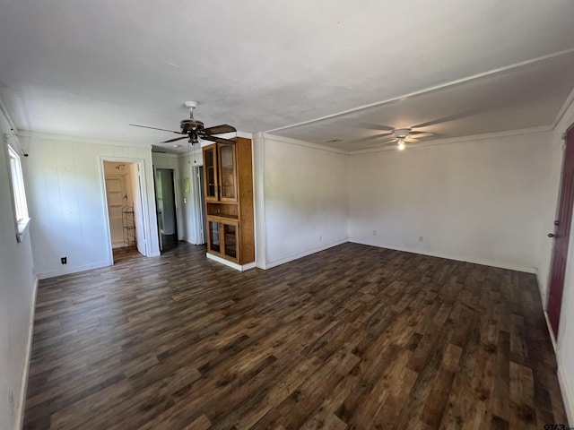 201 First St, Naples, TX 75568 - unfurnished living room featuring a ceiling fan, crown molding, dark wood-style flooring, and baseboards