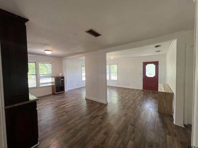 201 First St, Naples, TX 75568 - unfurnished living room with dark wood finished floors, baseboards, and healthy amount of natural light