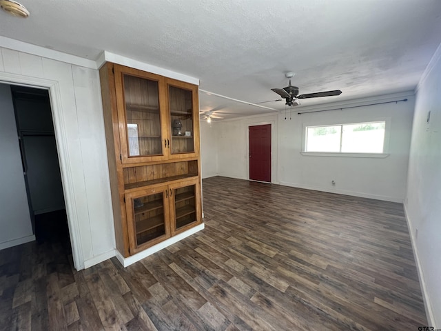 201 First St, Naples, TX 75568 - unfurnished living room featuring a ceiling fan, dark wood-type flooring, baseboards, and ornamental molding