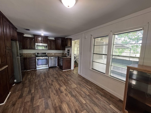 201 First St, Naples, TX 75568 - kitchen with appliances with stainless steel finishes, a sink, dark wood-type flooring, dark brown cabinetry, and healthy amount of natural light