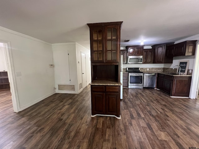 201 First St, Naples, TX 75568 - kitchen featuring appliances with stainless steel finishes, a sink, and dark wood-type flooring