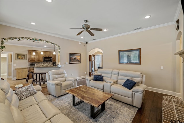 living room featuring baseboards, visible vents, arched walkways, light wood-style flooring, and crown molding