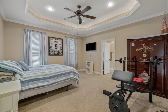 bedroom featuring light carpet, baseboards, ornamental molding, and a raised ceiling