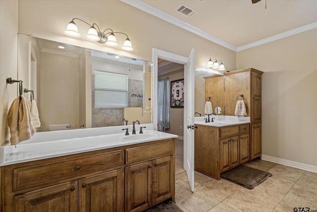 bathroom featuring two vanities, a sink, baseboards, visible vents, and crown molding