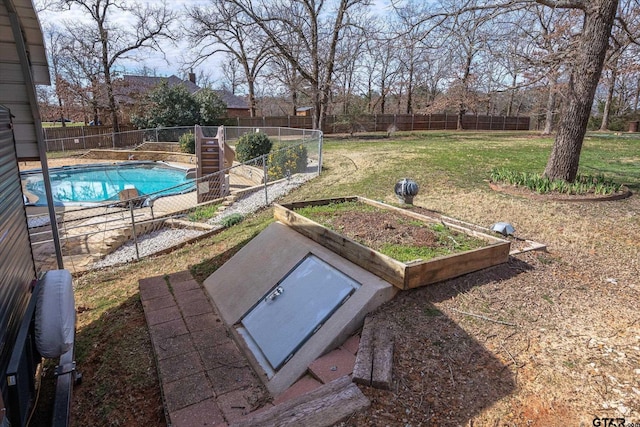 entry to storm shelter with a lawn and a fenced backyard