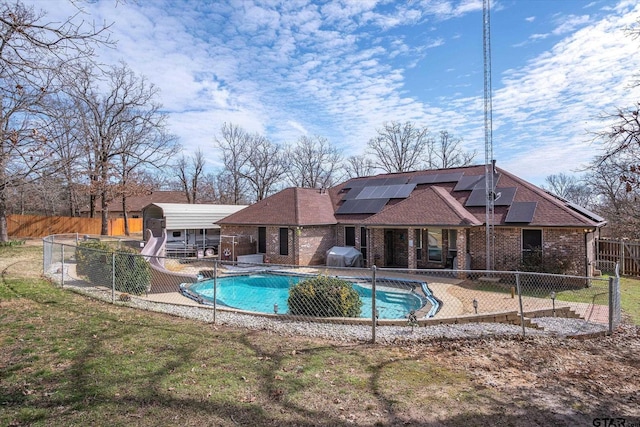 view of swimming pool with a fenced in pool, a lawn, a fenced backyard, grilling area, and a water slide