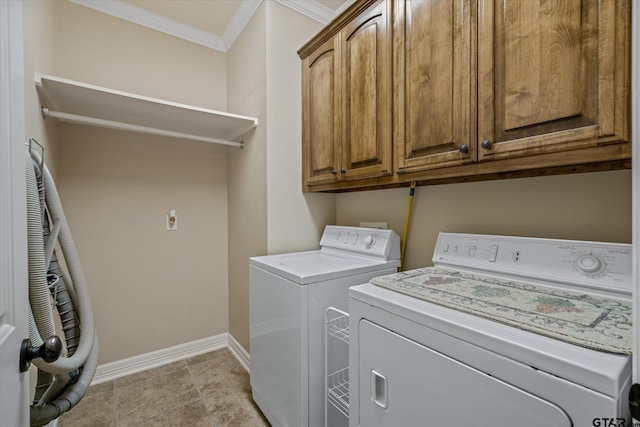 laundry area with light tile patterned floors, washing machine and dryer, baseboards, cabinet space, and crown molding