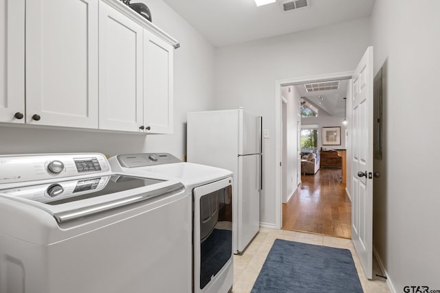 1509 Panther Creek Pass, Mount Vernon, TX 75457 - laundry room featuring washing machine and dryer, cabinet space, baseboards, and light tile patterned flooring