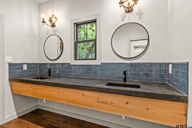 1509 Panther Creek Pass, Mount Vernon, TX 75457 - bathroom featuring decorative backsplash, double vanity, and wood finished floors