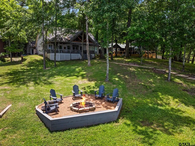 1509 Panther Creek Pass, Mount Vernon, TX 75457 - view of green lawn with a fire pit