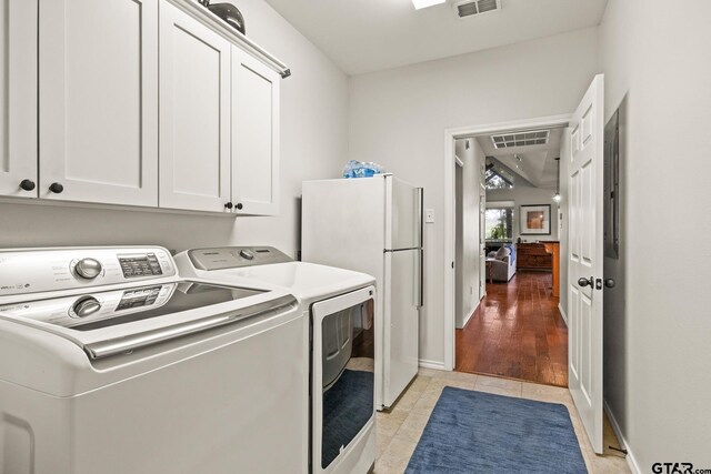 1509 Panther Creek Pass, Mount Vernon, TX 75457 - washroom with washer and clothes dryer, cabinet space, light tile patterned floors, and baseboards