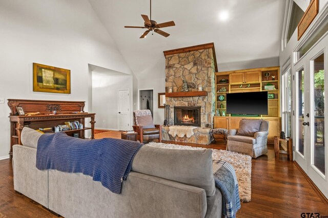 1509 Panther Creek Pass, Mount Vernon, TX 75457 - living area with high vaulted ceiling, a ceiling fan, a stone fireplace, dark wood finished floors, and baseboards
