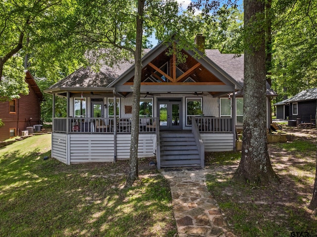 1509 Panther Creek Pass, Mount Vernon, TX 75457 - rear view of property featuring a ceiling fan, a chimney, stairway, french doors, and a yard