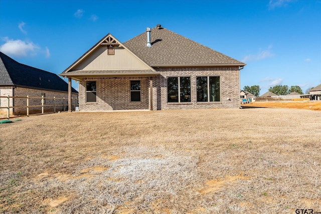 back of house featuring a yard