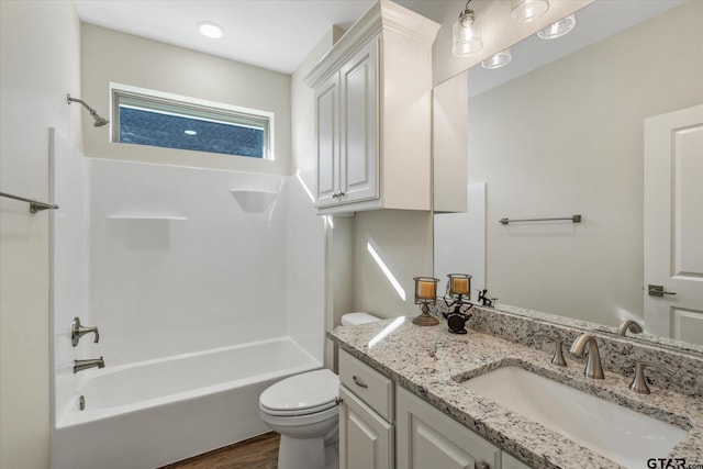 full bathroom featuring vanity, hardwood / wood-style flooring, shower / tub combination, and toilet