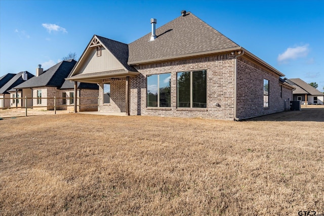 rear view of property with a yard