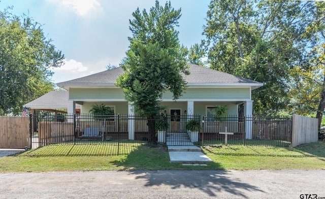 view of front of property with a front yard and a carport