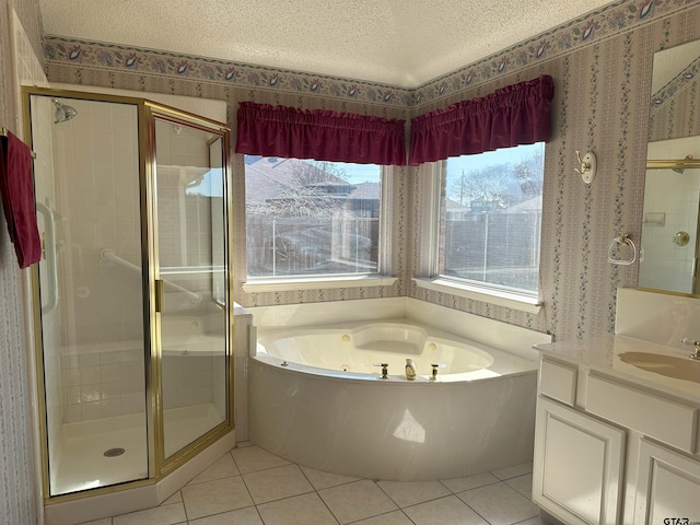 bathroom with vanity, tile patterned floors, independent shower and bath, and a textured ceiling