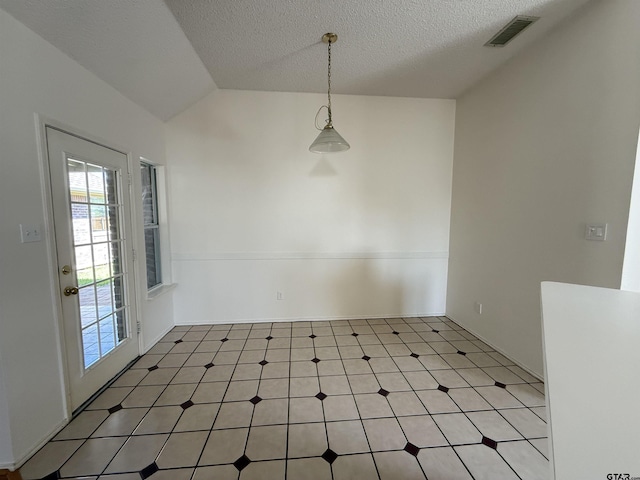 2414 Stillwater Dr, Mesquite, TX 75181 - unfurnished dining area with light flooring, a textured ceiling, and lofted ceiling