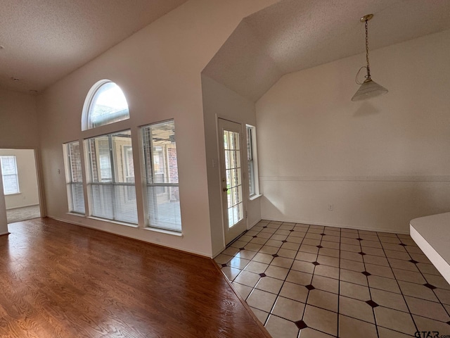 2414 Stillwater Dr, Mesquite, TX 75181 - interior space with plenty of natural light, a textured ceiling, light wood-type flooring, and vaulted ceiling