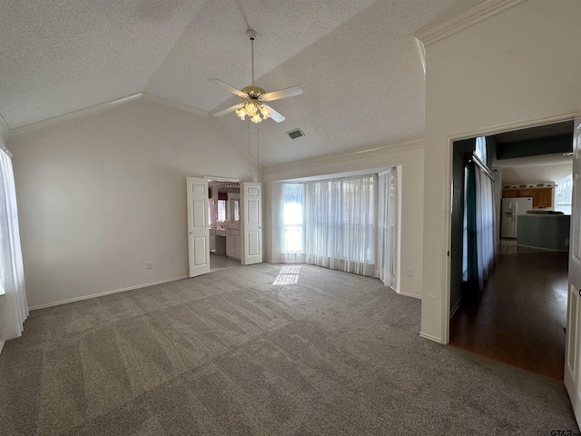 unfurnished living room with ceiling fan, ornamental molding, carpet floors, and a textured ceiling