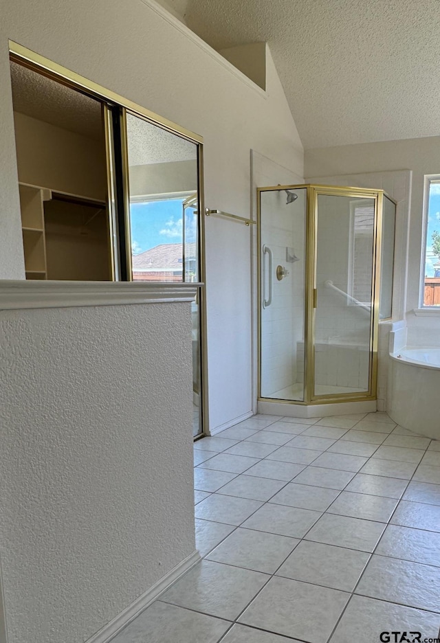 2414 Stillwater Dr, Mesquite, TX 75181 - full bathroom featuring tile patterned flooring, a textured ceiling, a stall shower, a bath, and vaulted ceiling