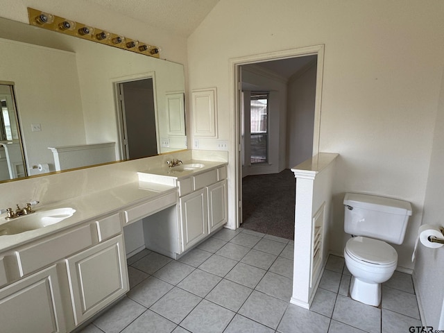 2414 Stillwater Dr, Mesquite, TX 75181 - full bathroom with vaulted ceiling, double vanity, and tile patterned flooring