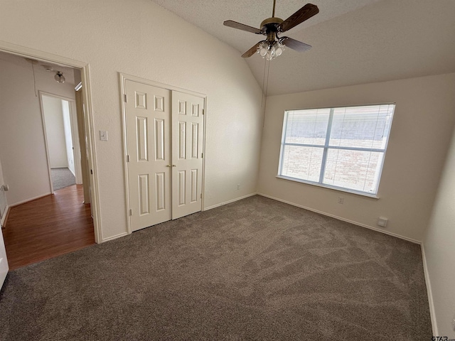 2414 Stillwater Dr, Mesquite, TX 75181 - unfurnished bedroom featuring vaulted ceiling, dark colored carpet, a closet, and ceiling fan