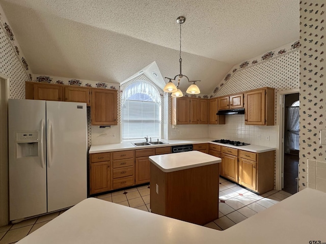 kitchen featuring lofted ceiling, sink, decorative light fixtures, a kitchen island, and white refrigerator with ice dispenser