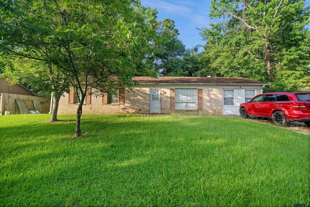 2313 Danica Dr, Tyler, TX 75701 - ranch-style house with a front lawn and brick siding