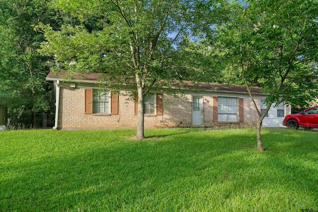 2313 Danica Dr, Tyler, TX 75701 - view of front of property with brick siding and a front lawn