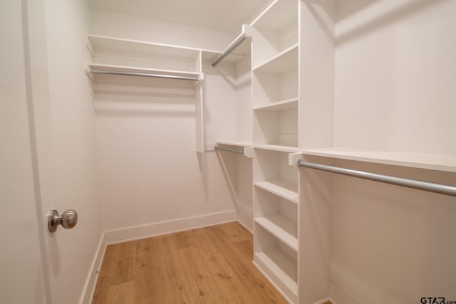 spacious closet with light hardwood / wood-style floors