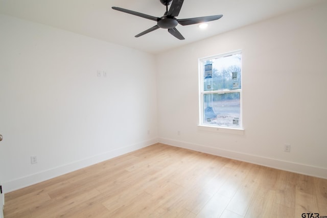 unfurnished room with a wealth of natural light, light hardwood / wood-style floors, and ceiling fan