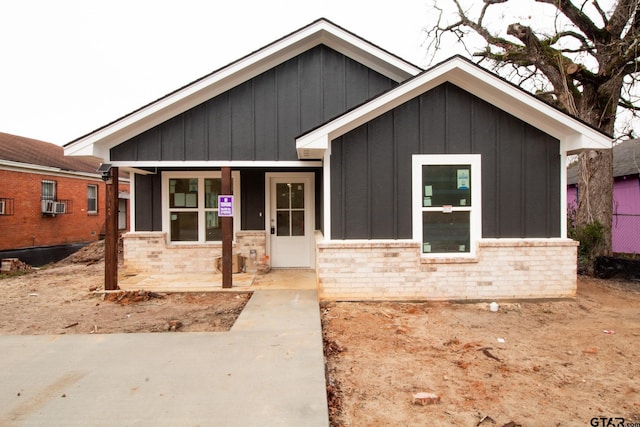 view of front of home featuring cooling unit and covered porch