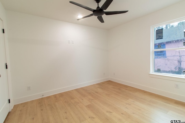 spare room with a wealth of natural light, light hardwood / wood-style floors, and ceiling fan