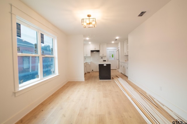 unfurnished living room with a wealth of natural light and light hardwood / wood-style flooring