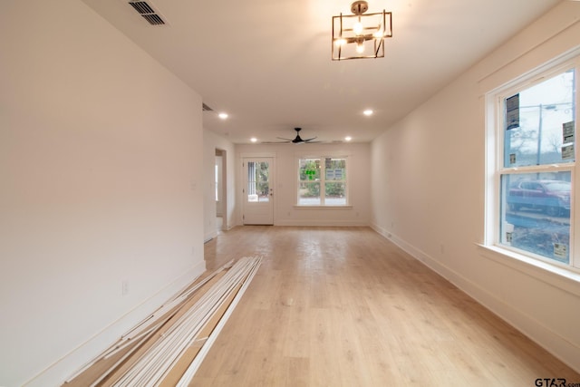 unfurnished living room with ceiling fan and light wood-type flooring