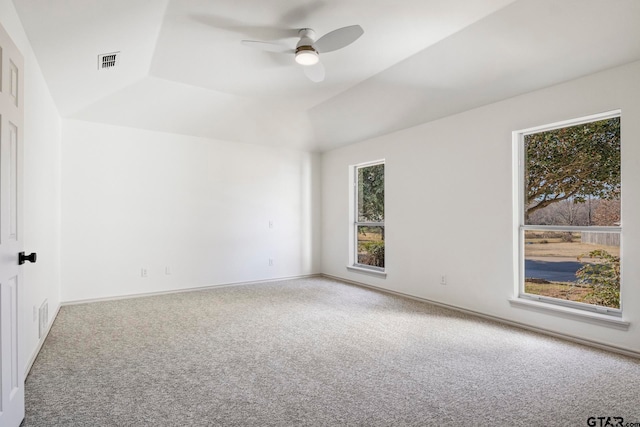 empty room featuring ceiling fan, carpet floors, and lofted ceiling