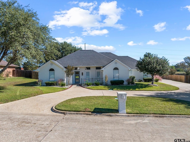 ranch-style home with a front yard