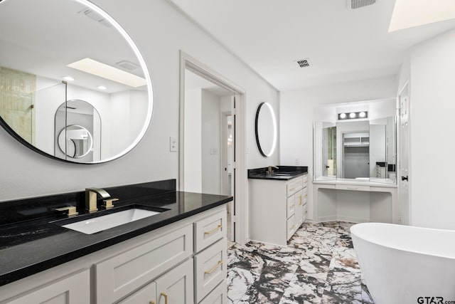 bathroom featuring vanity, separate shower and tub, and a skylight