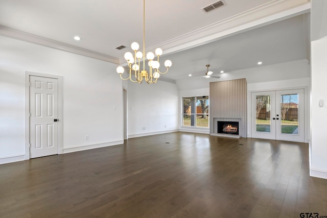 unfurnished living room with french doors, dark wood-type flooring, ornamental molding, and a healthy amount of sunlight