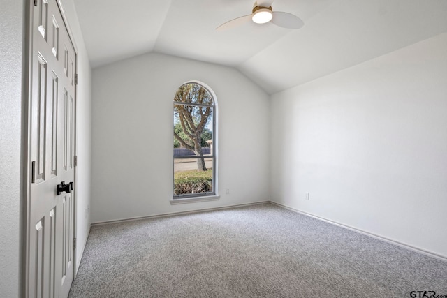 interior space with carpet, ceiling fan, and lofted ceiling