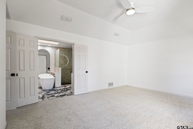 unfurnished bedroom featuring carpet flooring, ceiling fan, and ensuite bath