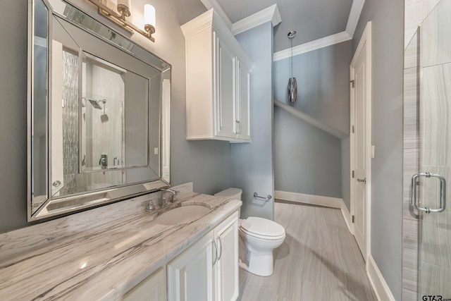 bathroom with walk in shower, vanity, toilet, and crown molding